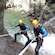 Two Guests posing for a picture while rappelling down a waterfall in the Richiusa Canyon at Corsica